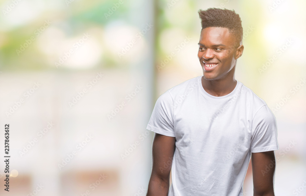 Young african american man over isolated background looking away to side with smile on face, natural expression. Laughing confident. Young african american man over isolated background looking away to side with smile on face, natural expression. Laughing confident.