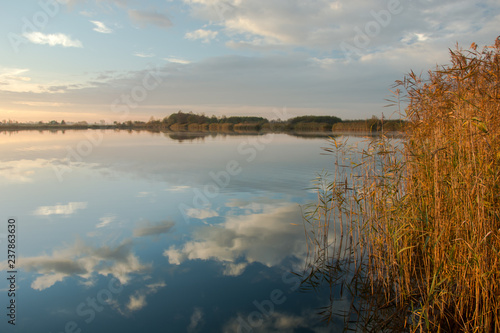 Small fog in the morning and reflection of clouds in the lake © darekb22