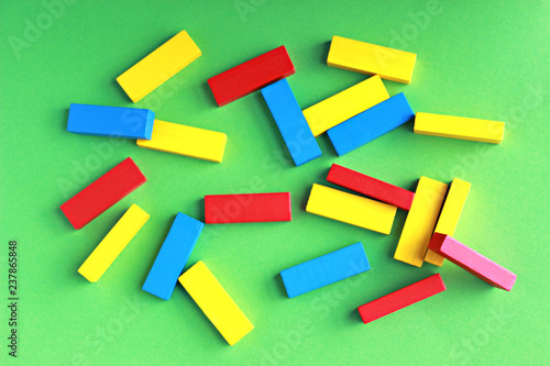 multi colored toy blocks lying on a green background