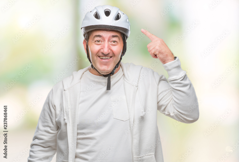 Handsome senior cyclist man wearing bike helmet over isolated background very happy pointing with hand and finger Handsome senior cyclist man wearing bike helmet over isolated background very happy pointing with hand and finger