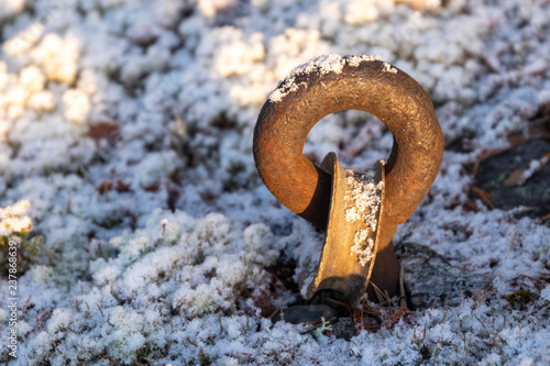 Cast iron link in frozen ground photo