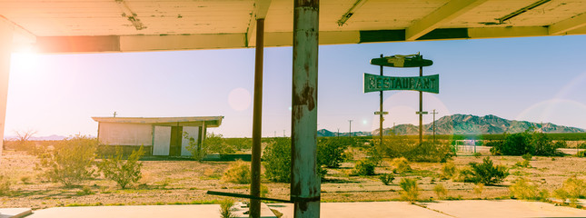 Acrylglasbilder Route 66 Abandoned gas station and resturaunt on route 66 in California, cross processed vintage sun flare colour effect  © Gabriel Cassan