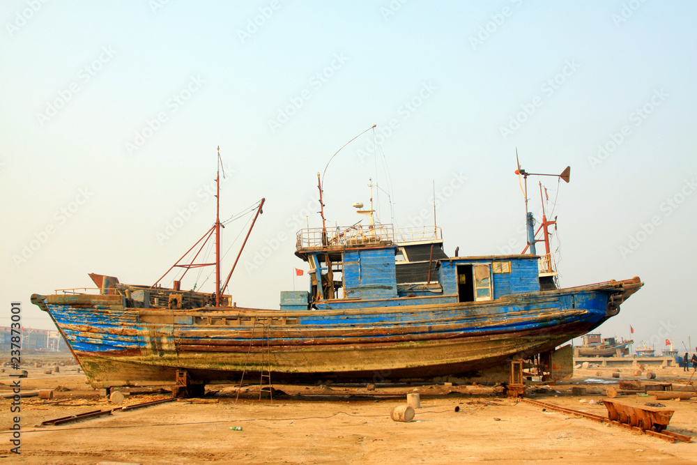 Wooden fishing boat waiting for repair