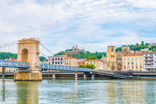 Slika na platnu Cathedral in Vienne viewed behind a pedestrian bridge over river Rhone, France