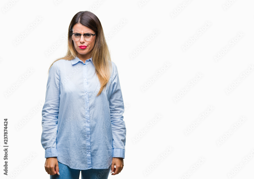 Young beautiful business woman wearing glasses over isolated background skeptic and nervous, frowning upset because of problem. Negative person. Young beautiful business woman wearing glasses over isolated background skeptic and nervous, frowning upset because of problem. Negative person.