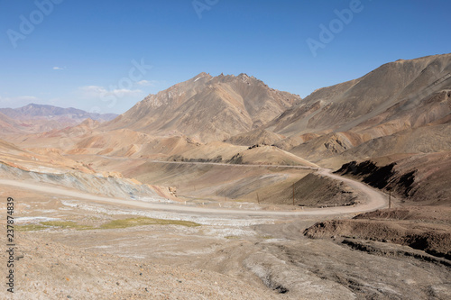 Desert landscape in the area of Ak-Baital Pass with road in the Pamir Mountains in Tajikistan