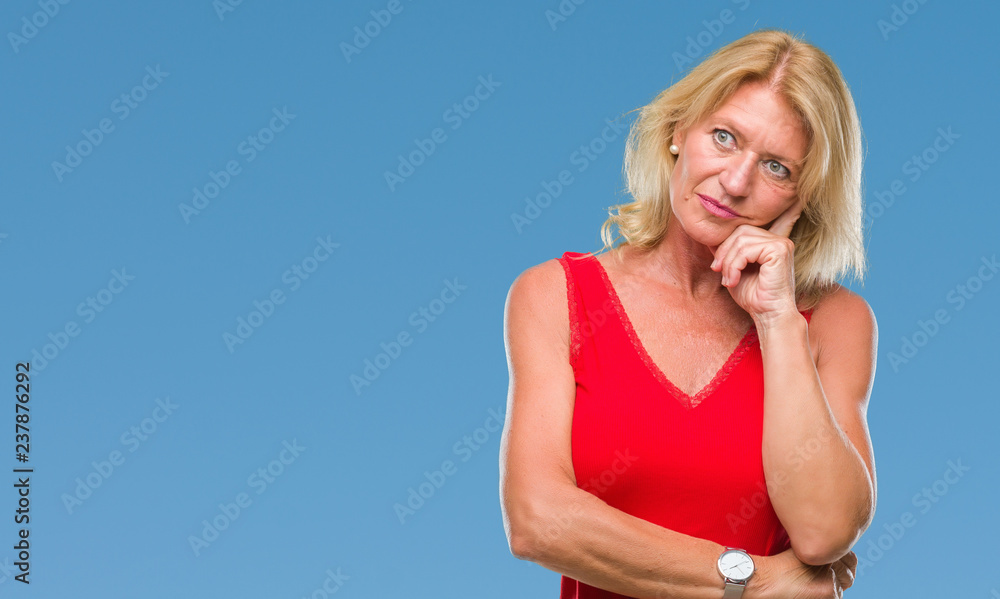 Middle age blonde woman over isolated background thinking looking tired and bored with depression problems with crossed arms.