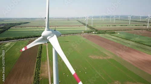 Drone footage of Wind turbines in Burgerland, Austria. Late spring - early summer 2018. SUPER CLOSE view of Turbine over farm fields. photo