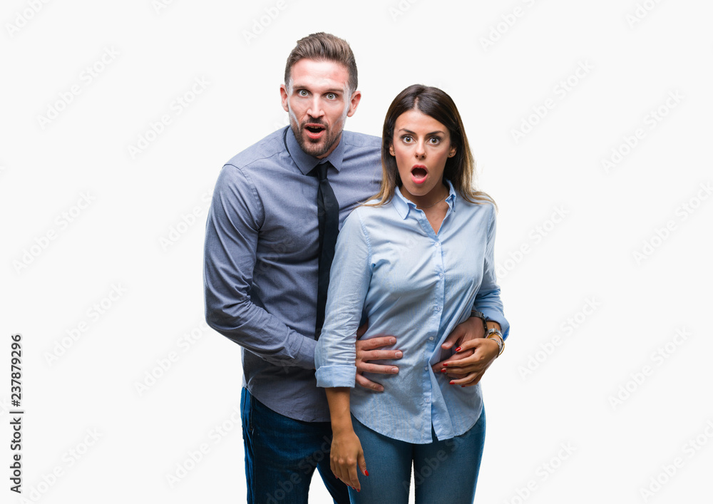 Young workers business couple over isolated background afraid and shocked with surprise expression, fear and excited face. Young workers business couple over isolated background afraid and shocked with surprise expression, fear and excited face.