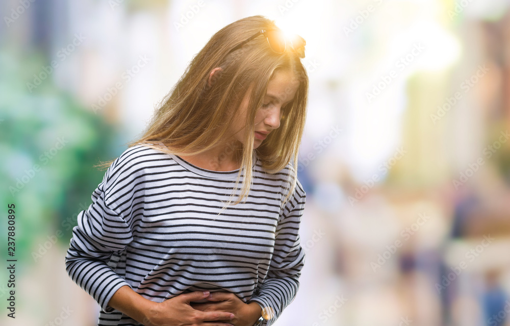 Young beautiful blonde woman wearing sunglasses over isolated background with hand on stomach because nausea, painful disease feeling unwell. Ache concept.