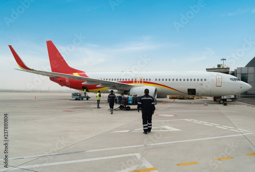 A passenger plane being serviced by ground services before next takeoff