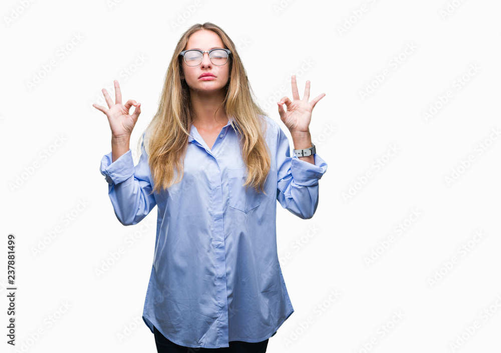Young beautiful blonde business woman wearing glasses over isolated background relax and smiling with eyes closed doing meditation gesture with fingers. Yoga concept. Young beautiful blonde business woman wearing glasses over isolated background relax and smiling with eyes closed doing meditation gesture with fingers. Yoga concept.