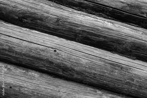 row of gray round logs horizontal weathering surface cracked old rustic background base monochrome