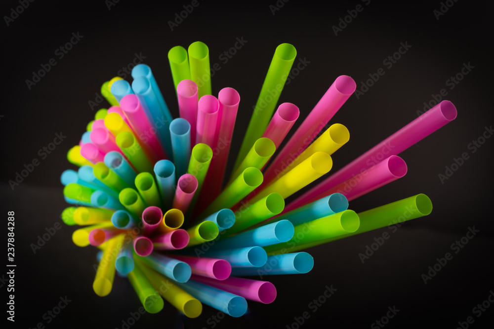 Colorful straws in front of black background Colorful straws in front of black background
