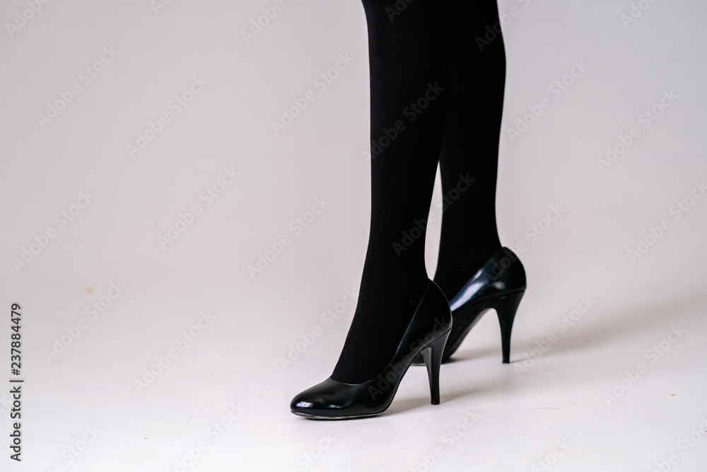 Foto Stock women's feet in black stockings or tights, black high-heeled  shoes. | Adobe Stock