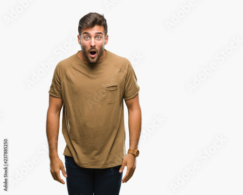 Young handsome man over isolated background afraid and shocked with surprise expression, fear and excited face. © Krakenimages.com