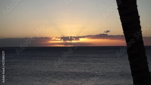 Looking into the sunset from Playa de Puerto Naos. Sun is hidden behind clouds. photo