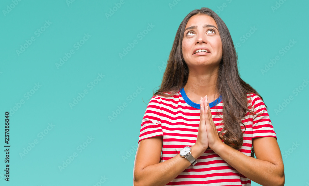 Young beautiful arab woman over isolated background begging and praying with hands together with hope expression on face very emotional and worried. Asking for forgiveness. Religion concept. Young beautiful arab woman over isolated background begging and praying with hands together with hope expression on face very emotional and worried. Asking for forgiveness. Religion concept.