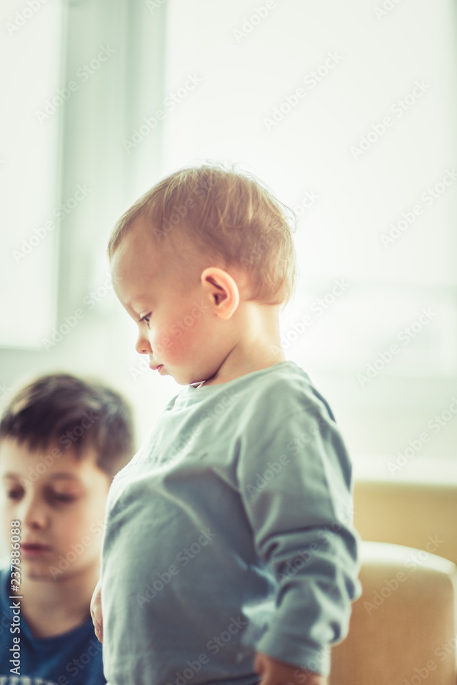 Two young kids playing inside the apartment Two young kids playing inside the apartment