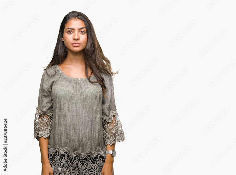 Obraz premium Young beautiful arab woman over isolated background with serious expression on face. Simple and natural looking at the camera.