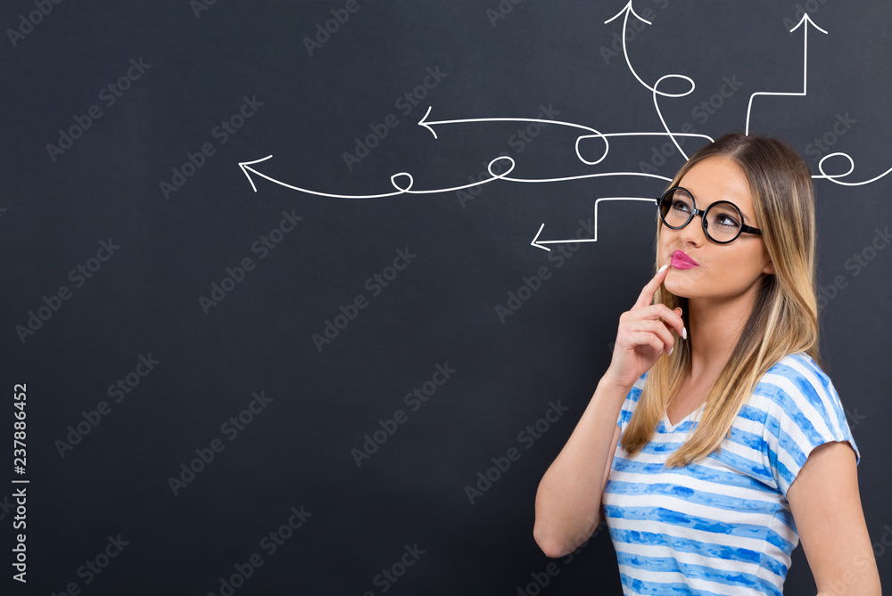 Idea arrows with young woman in front of a blackboard Idea arrows with young woman in front of a blackboard