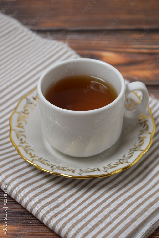 A Cup of fragrant tea on a wooden background. A Cup of fragrant tea on a wooden background.