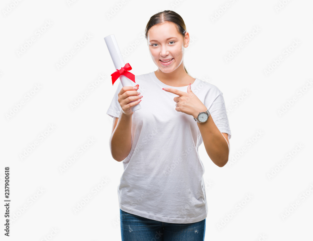 Young caucasian woman holding degree over isolated background very happy pointing with hand and finger Young caucasian woman holding degree over isolated background very happy pointing with hand and finger