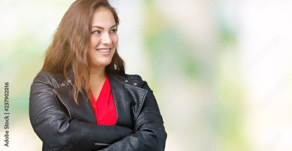 Beautiful plus size young woman wearing a fashion leather jacket over isolated background smiling looking to the side with arms crossed convinced and confident Beautiful plus size young woman wearing a fashion leather jacket over isolated background smiling looking to the side with arms crossed convinced and confident