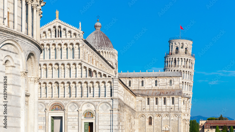 Day view of Pisa Cathedral with Leaning Tower of Pisa on Piazza dei Miracoli in Pisa, Tuscany, Italy. The Leaning Tower of Pisa is one of the main landmark of Italy