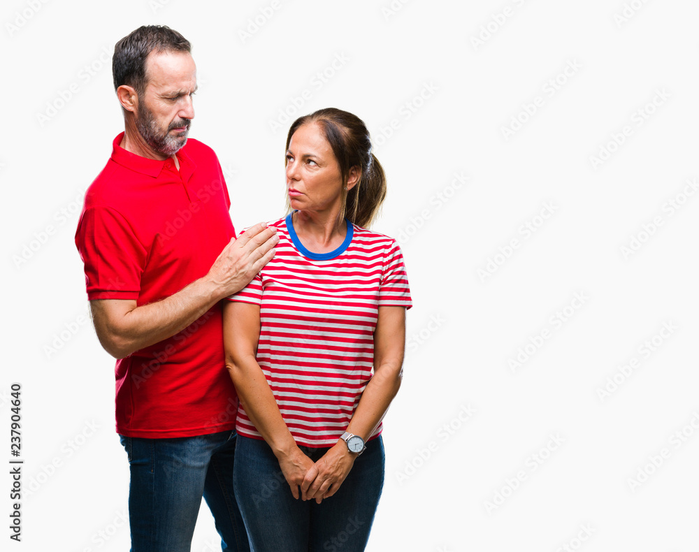 Middle age hispanic couple in love over isolated background skeptic and nervous, frowning upset because of problem. Negative person. Middle age hispanic couple in love over isolated background skeptic and nervous, frowning upset because of problem. Negative person.