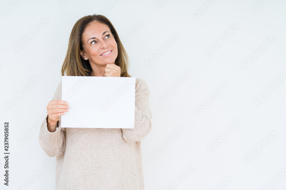 Middle age woman holding blank paper sheet over isolated background serious face thinking about question, very confused idea Middle age woman holding blank paper sheet over isolated background serious face thinking about question, very confused idea