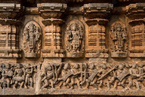 Artistic stone sculptures and carvings of Hindu Gods and Goddesses at Somanathapura Temple in Karnataka, India.  photo