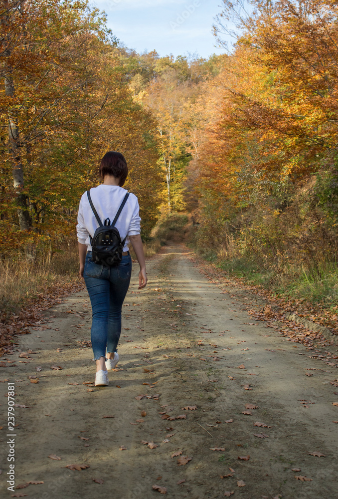 Fototapeta premium Girl Walking on a Hiking Trail