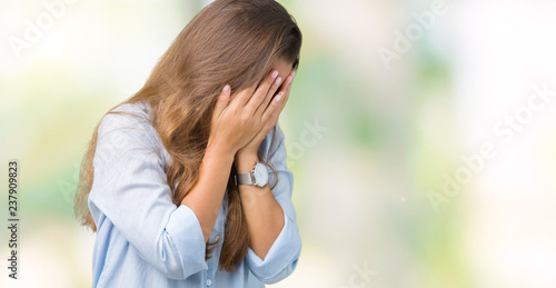 Young beautiful brunette business woman over isolated background with sad expression covering face with hands while crying. Depression concept.