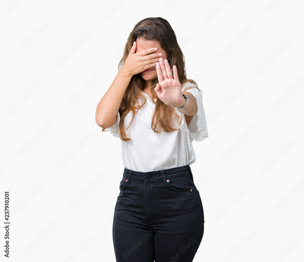 Young beautiful brunette business woman over isolated background covering eyes with hands and doing stop gesture with sad and fear expression. Embarrassed and negative concept. Young beautiful brunette business woman over isolated background covering eyes with hands and doing stop gesture with sad and fear expression. Embarrassed and negative concept.
