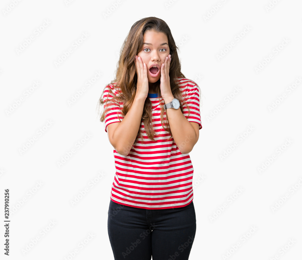 Young beautiful brunette woman wearing stripes t-shirt over isolated background afraid and shocked with surprise expression, fear and excited face. Young beautiful brunette woman wearing stripes t-shirt over isolated background afraid and shocked with surprise expression, fear and excited face.