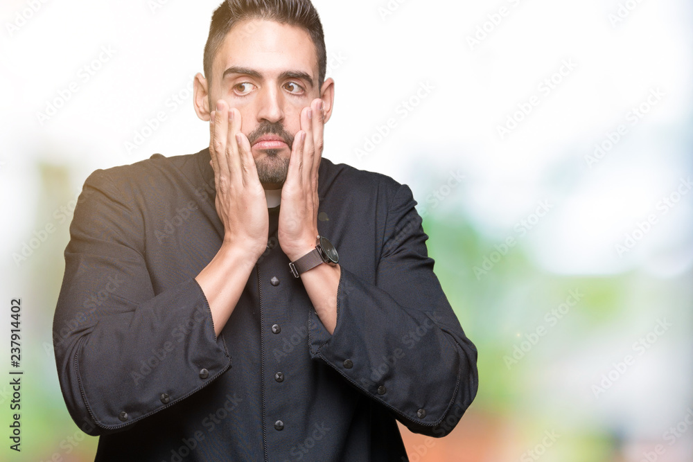 Young Christian priest over isolated background Tired hands covering face, depression and sadness, upset and irritated for problem Young Christian priest over isolated background Tired hands covering face, depression and sadness, upset and irritated for problem