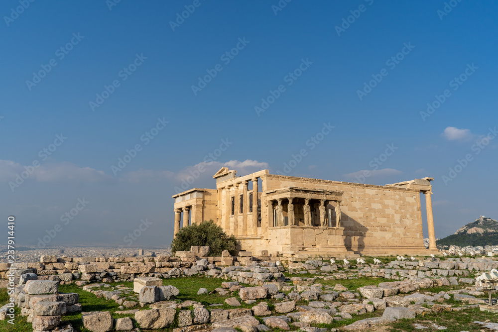 The Caryatid Porch visible as part of the ancient Erechtheion Temple in the Acropolis, in Athens, Greece. The Caryatid Porch visible as part of the ancient Erechtheion Temple in the Acropolis, in Athens, Greece.