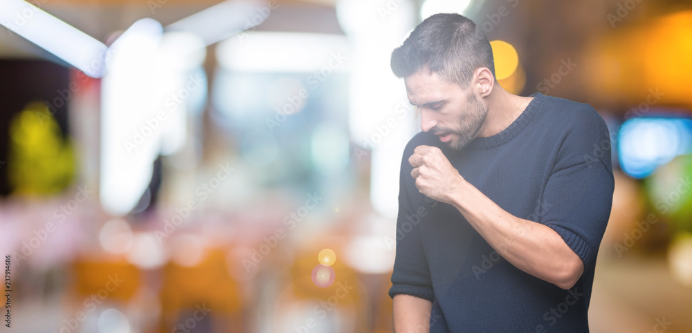 Young handsome man wearing sweater over isolated background feeling unwell and coughing as symptom for cold or bronchitis. Healthcare concept. Young handsome man wearing sweater over isolated background feeling unwell and coughing as symptom for cold or bronchitis. Healthcare concept.
