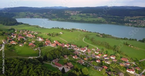 Aerial, pan, drone shot, of houses in les grangettes village, near Lac saint-point lake, in Franche comt√©, France photo