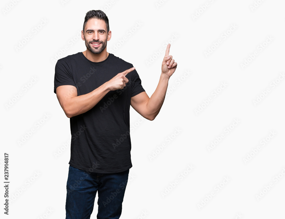 Young handsome man over isolated background smiling and looking at the camera pointing with two hands and fingers to the side. Young handsome man over isolated background smiling and looking at the camera pointing with two hands and fingers to the side.
