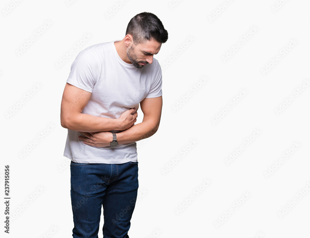Fototapeta premium Young man wearing casual white t-shirt over isolated background with hand on stomach because nausea, painful disease feeling unwell. Ache concept.