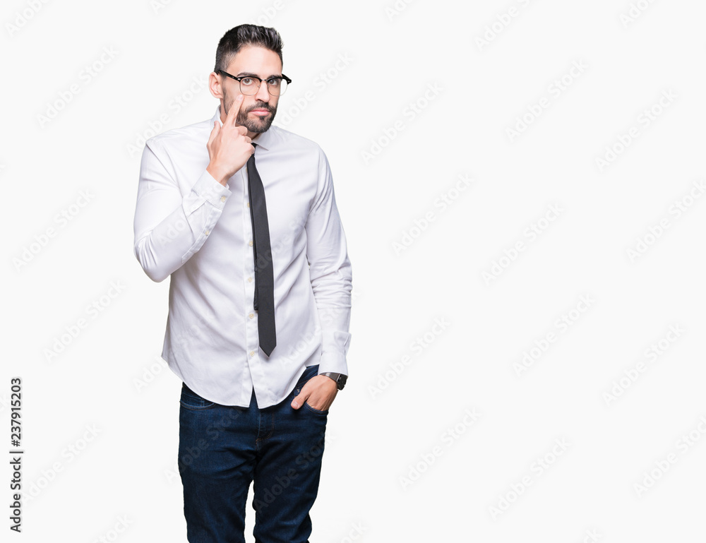 Young handsome business man wearing glasses over isolated background Pointing to the eye watching you gesture, suspicious expression Young handsome business man wearing glasses over isolated background Pointing to the eye watching you gesture, suspicious expression