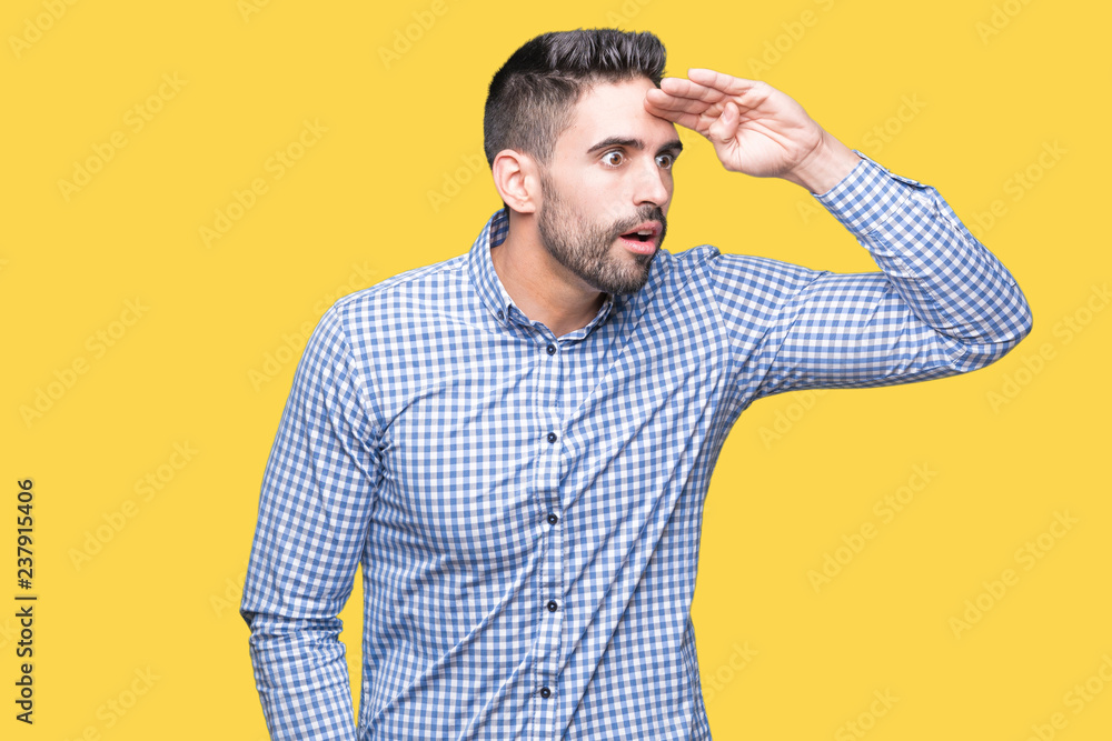 Young handsome man over isolated background very happy and smiling looking far away with hand over head. Searching concept. Young handsome man over isolated background very happy and smiling looking far away with hand over head. Searching concept.
