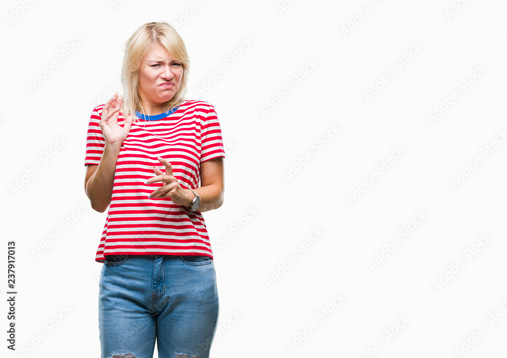 Young beautiful blonde woman over isolated background disgusted expression, displeased and fearful doing disgust face because aversion reaction. With hands raised. Annoying concept. Young beautiful blonde woman over isolated background disgusted expression, displeased and fearful doing disgust face because aversion reaction. With hands raised. Annoying concept.