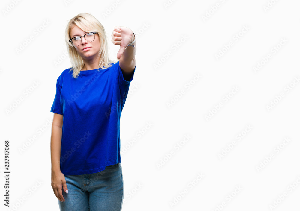 Young beautiful blonde woman wearing glasses over isolated background looking unhappy and angry showing rejection and negative with thumbs down gesture. Bad expression. Young beautiful blonde woman wearing glasses over isolated background looking unhappy and angry showing rejection and negative with thumbs down gesture. Bad expression.