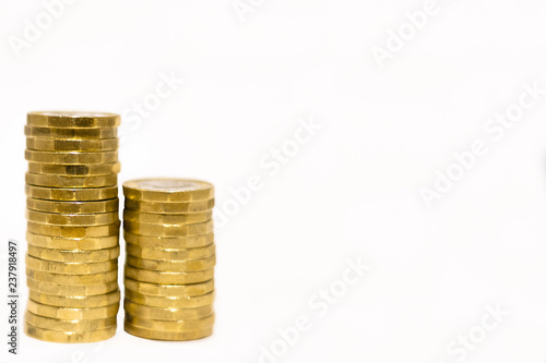 Stacks and Heaps of British GBP Golden Coins Currency Money on white background with empty space