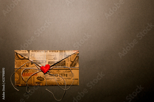 Letter with a heart on a gray background with copy space. Concept backgrounds for text on Valentine's Day.