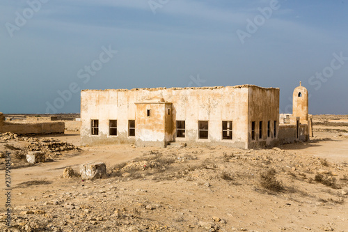 Ruined ancient old Arab pearling and fishing town Al Jumail, Qatar. The desert at coast of Persian Gulf. Minaret. Deserted village. Pile of stones