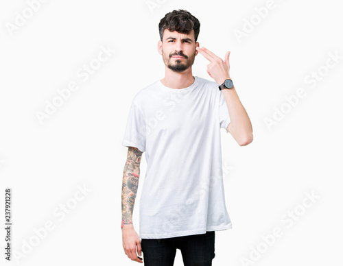 Photography Young handsome man wearing white t-shirt over isolated background Shooting and killing oneself pointing hand and fingers to head, suicide gesture